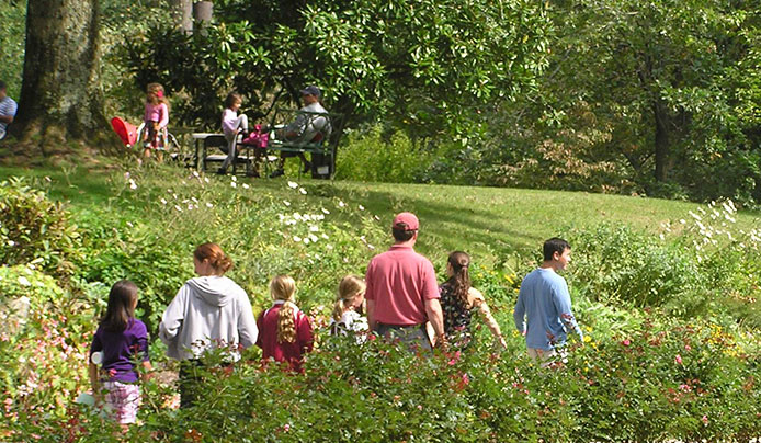 A tour group walking through the gardens on a serpentine path