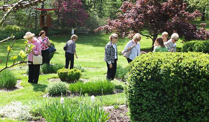 A large group tour through the herb gardens as they explore the horticulture and history of the arboretum