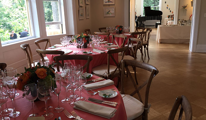 Tables set up for a private event with a piano