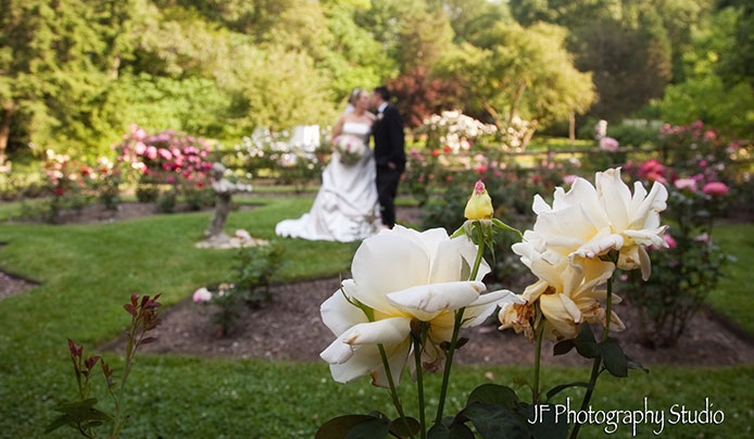 Bride and Groom at their wedding with white roses