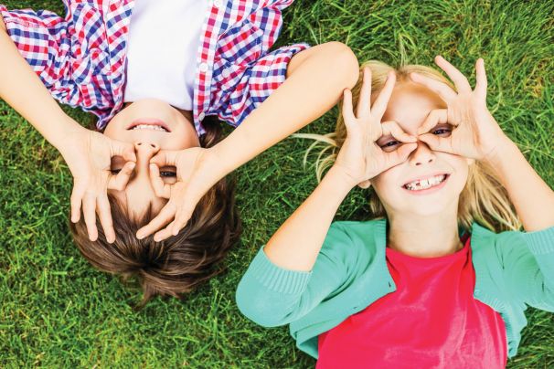 Lunch buddies playfully holding their hands around their eyes