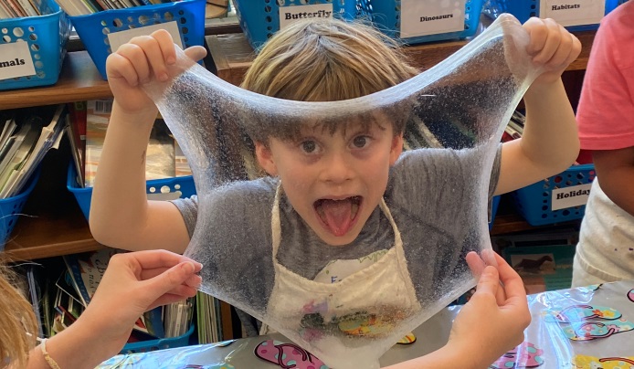 Boy looking through clear slime