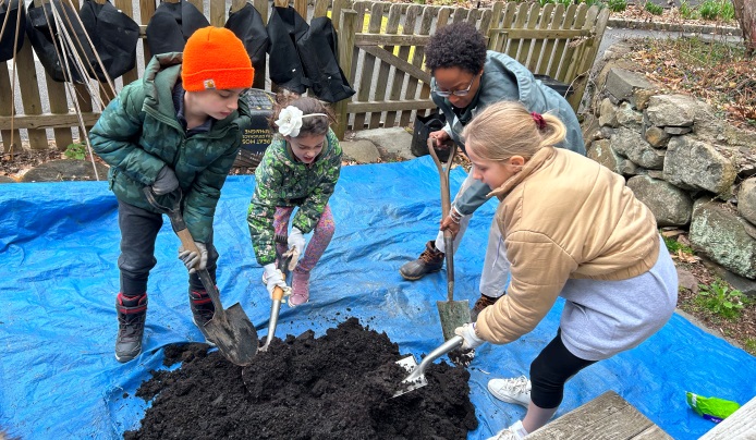 Children preparing garden soil