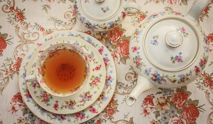 Fine chinaware filled with bright-colored tea