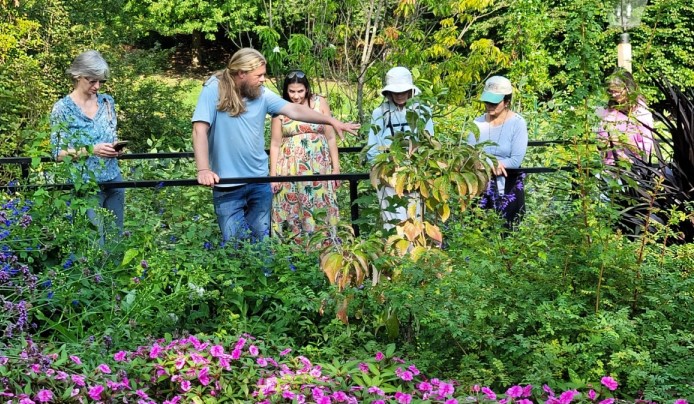 Early Autumn Walkabout with a tour guide explaining the plants the group is looking at