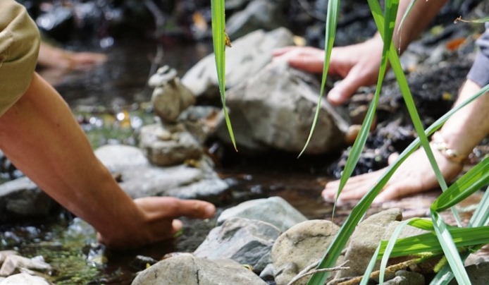 Touching rocks near a river