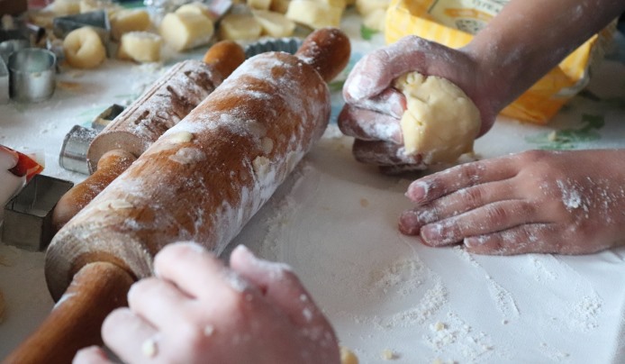 Kneading cookie dough with hands and a rolling pin